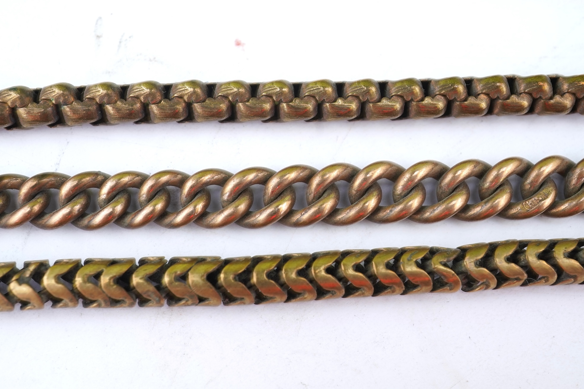 A group of gilt metal/pinchbeck jewels, 19th and early 20th century, comprising: a brooch of knotted design; two gate bracelets; a fancy link bracelet; an open-faced pocket watch; two oval panel brooches, and two watch c